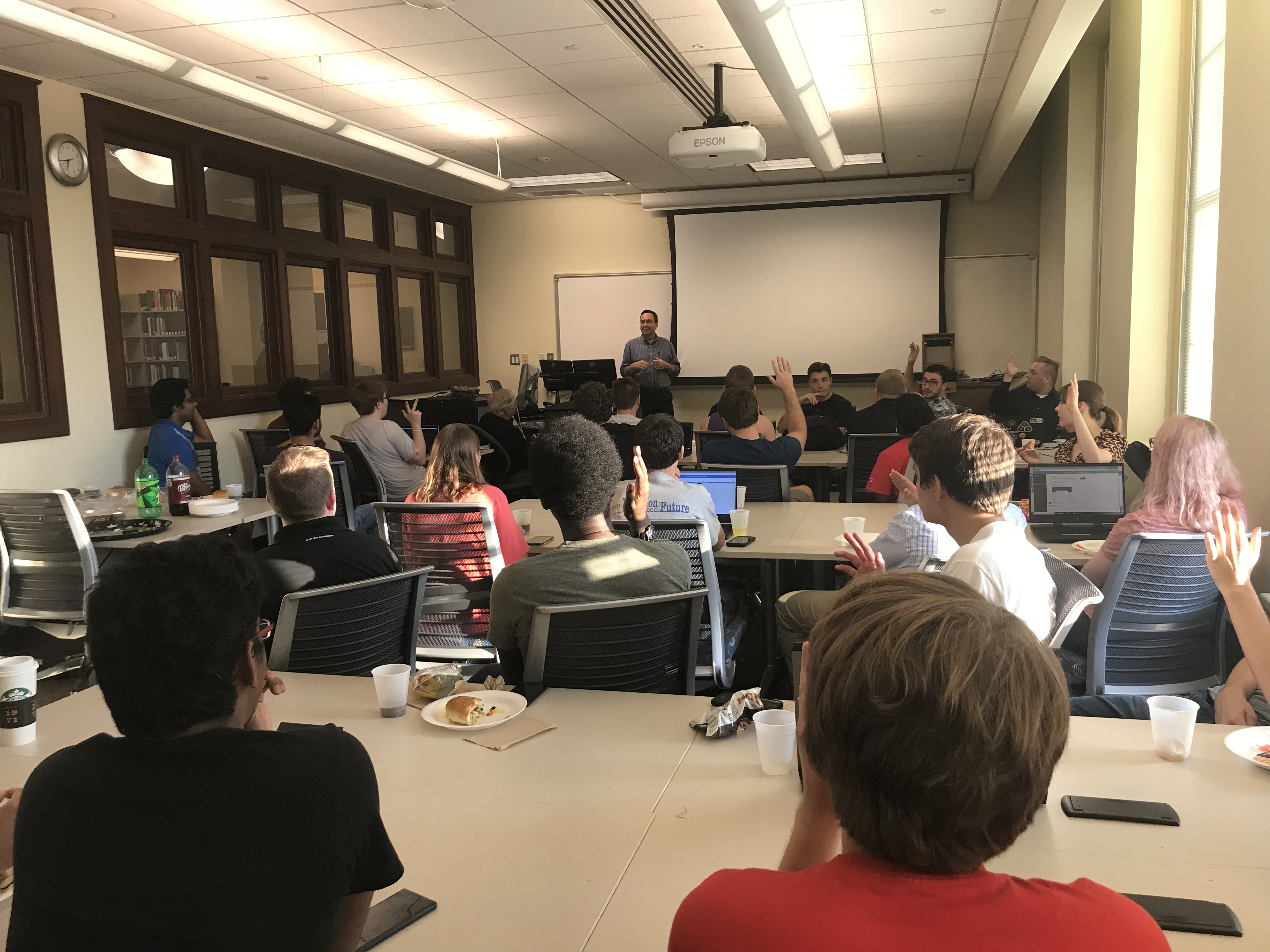 Jason Armstrong asking a question to a room full of students